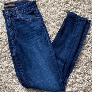 Skinny jeans with rips on knees. Dark blue.